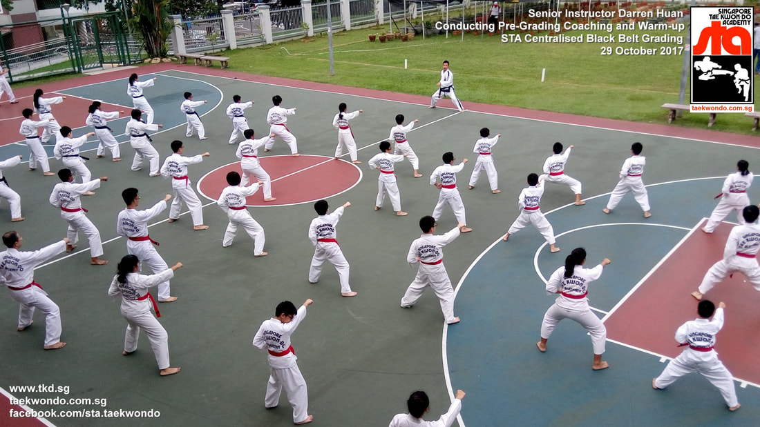 Mass Warm up Senior Instructor Darren Huan Centralised Black Belt Grading Singapore Taekwon-do Academy HQ STA Taekwondo International recognized 29 Oct 2017
